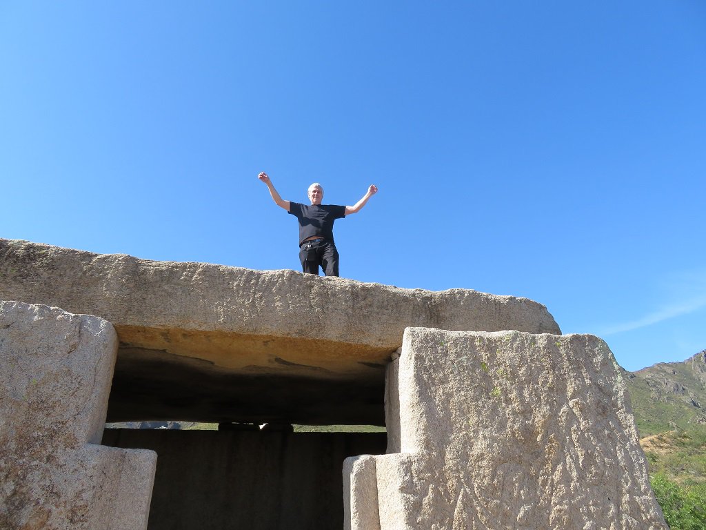 BabelStone standing triumphantly on top of an ancient structure made from large stone slabs